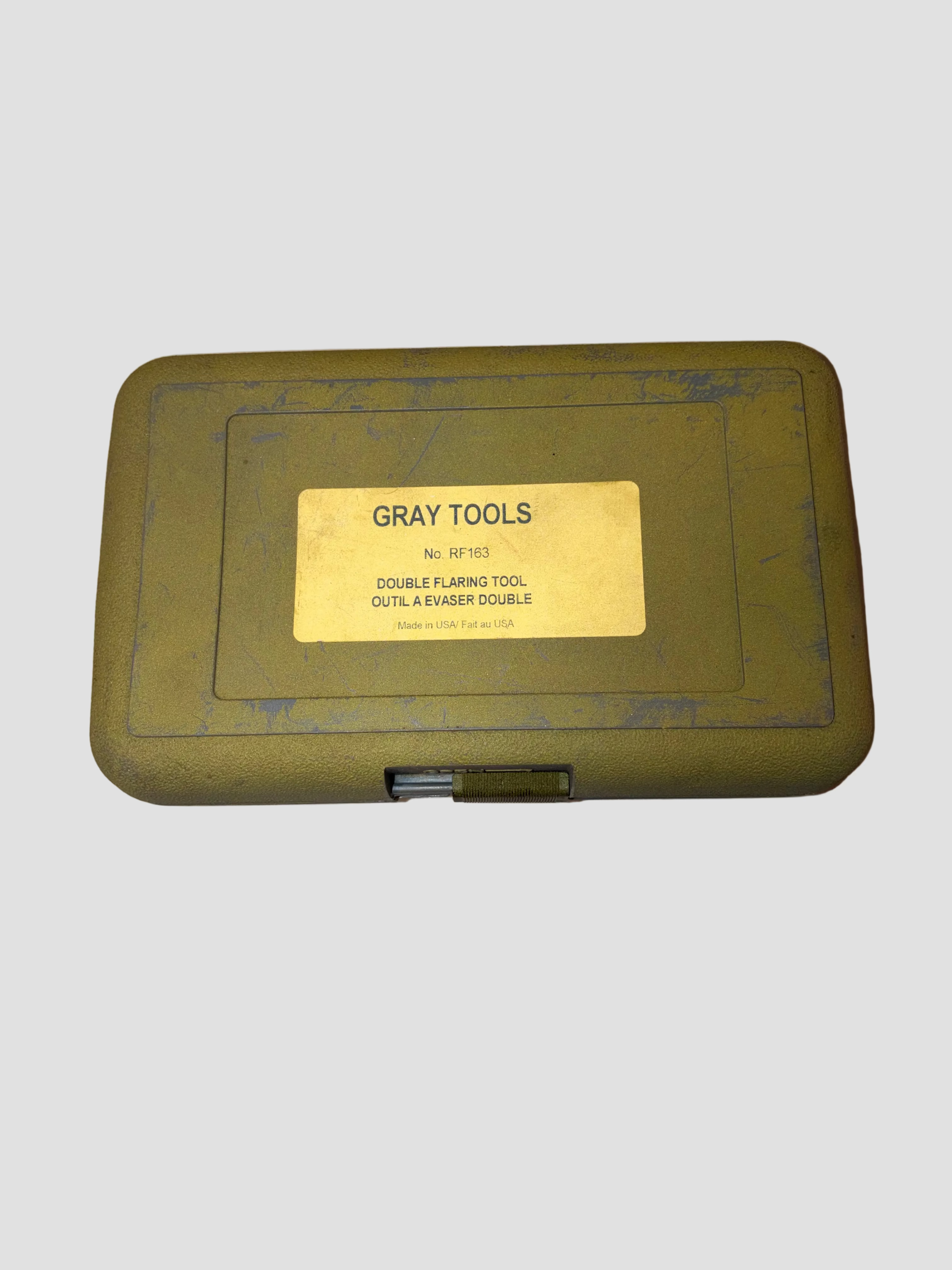 Green tool box with 'Gray Tools' label on a beige background