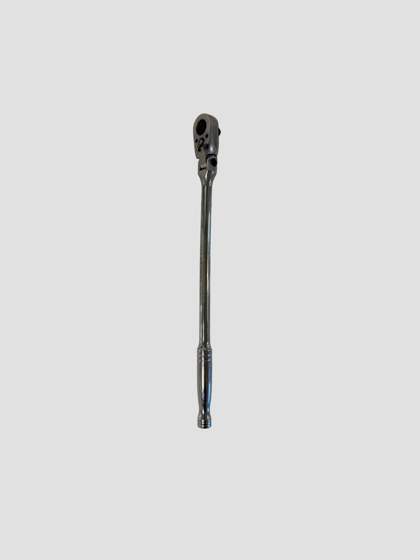 A chrome ratchet wrench positioned vertically against a plain light gray background. The tool has a long, polished handle with a rounded end and a pivoting ratchet head featuring a square drive socket connector and directional switch. The metallic surface reflects light, highlighting its smooth finish and durable construction.
