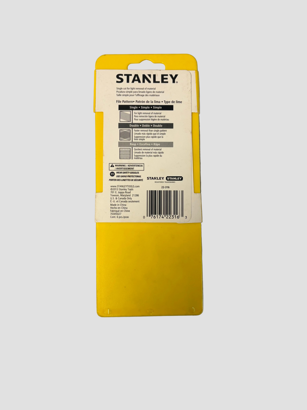 A yellow Stanley tool box or package insert photographed from the back on a plain gray surface. The Stanley logo is clearly visible at the top, with product text and a barcode on the white label area.
