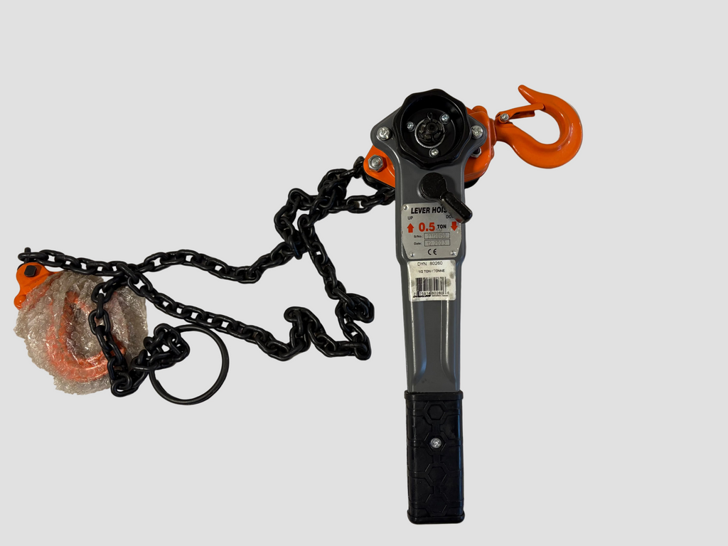 A manual chain hoist with an orange hook and black chain, shown on a plain off-white background with its plastic-wrapped orange hook still attached.