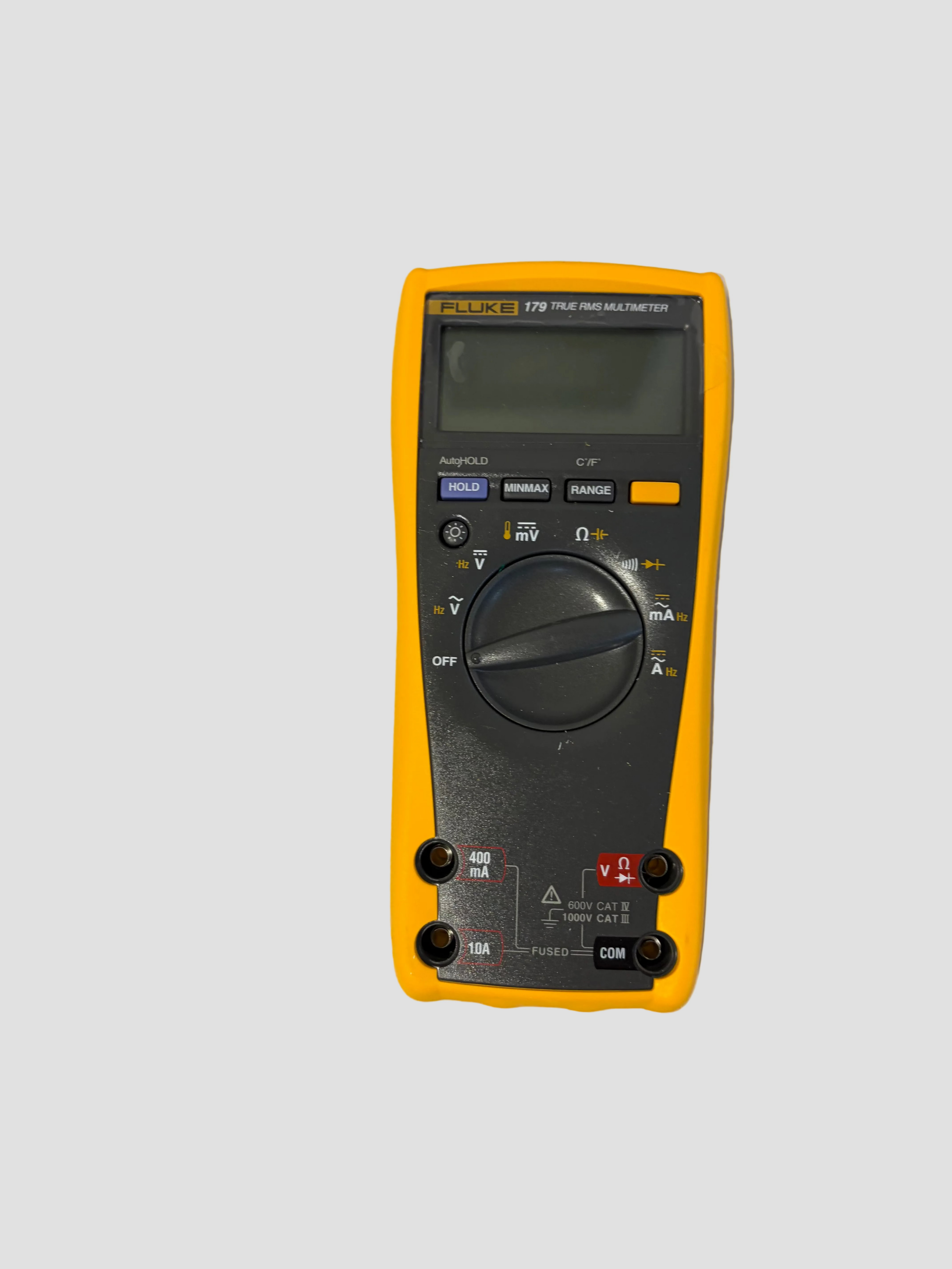 Yellow and black multimeter on a beige background