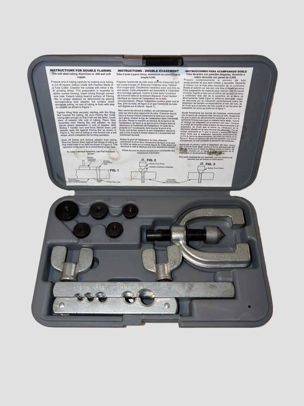 Tool kit with components and instructions on a light gray background