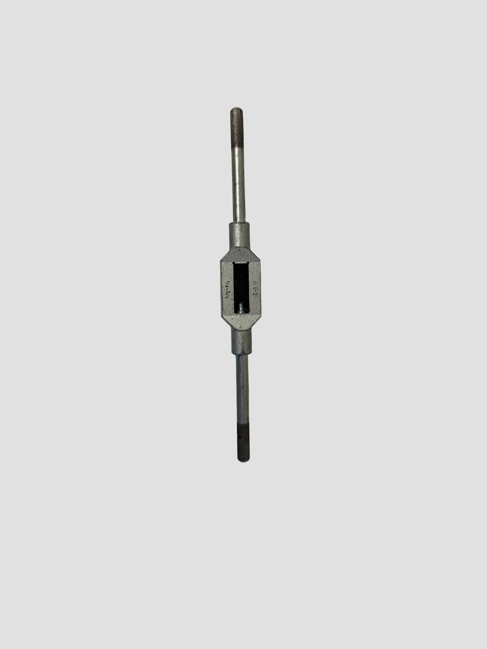 A metal tap tool with a silver body and dark gray handle, centered on a light gray background.