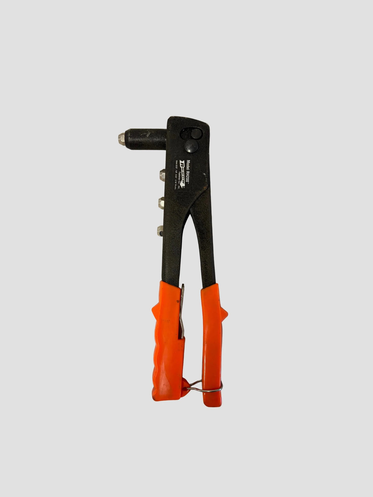 A black and orange rivet gun tool with a metal punch bit, shown against a solid light gray background.