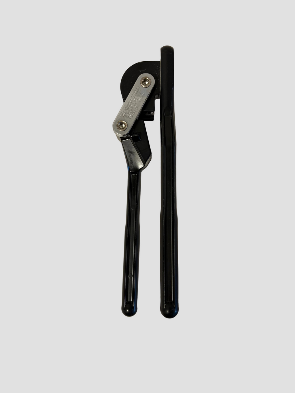 A black and silver metal pipe cutter tool with long handles, shown on a plain light gray surface.