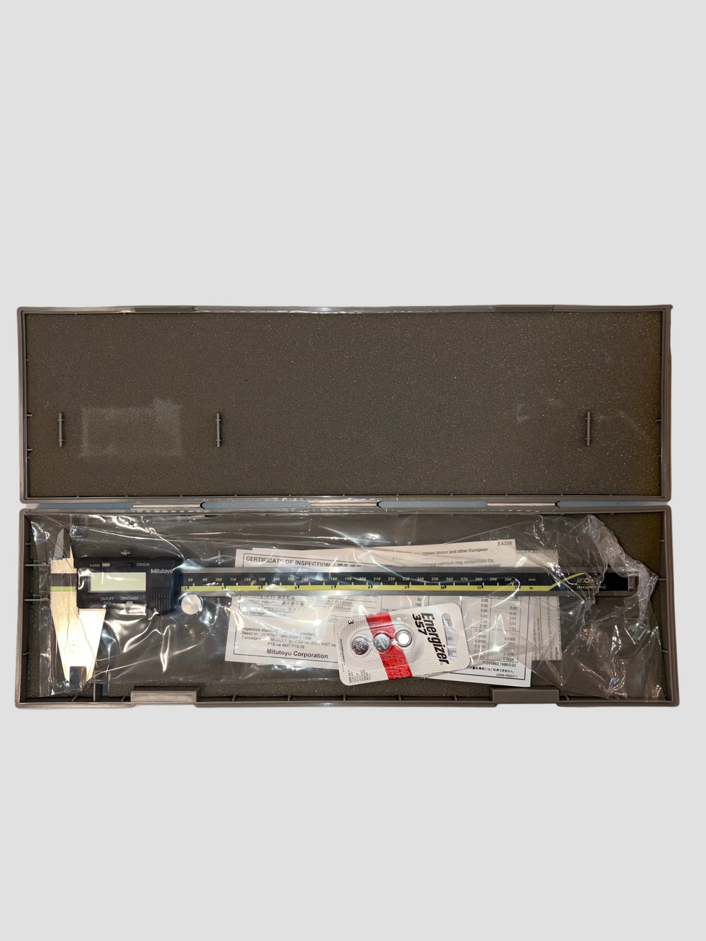 Open box containing electronic components on a gray background