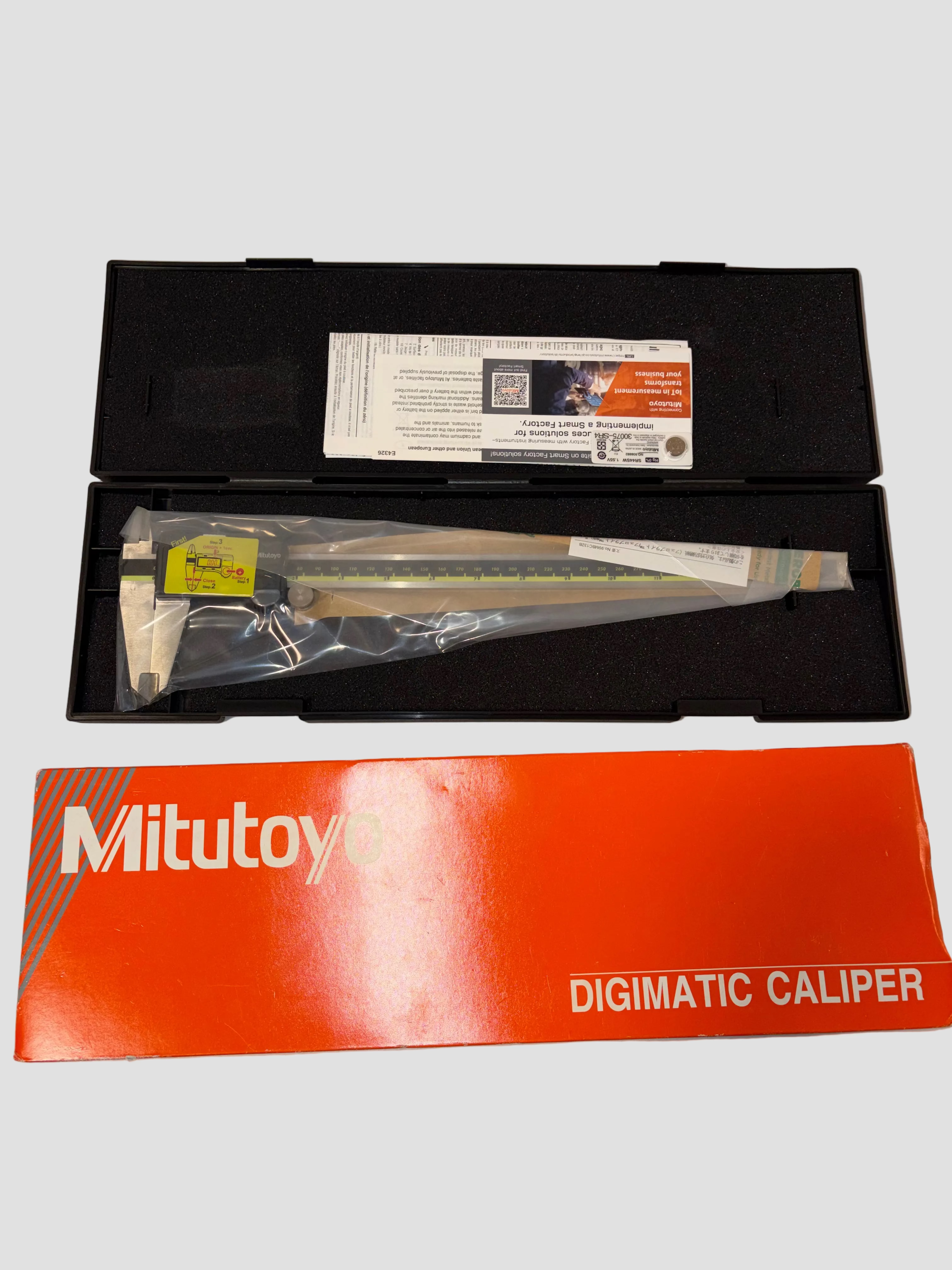 Mitutoyo Digimatic Caliper with packaging on a gray surface