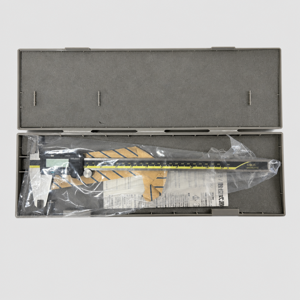 Digital vernier caliper in a protective plastic bag inside an open tool case on a light gray background