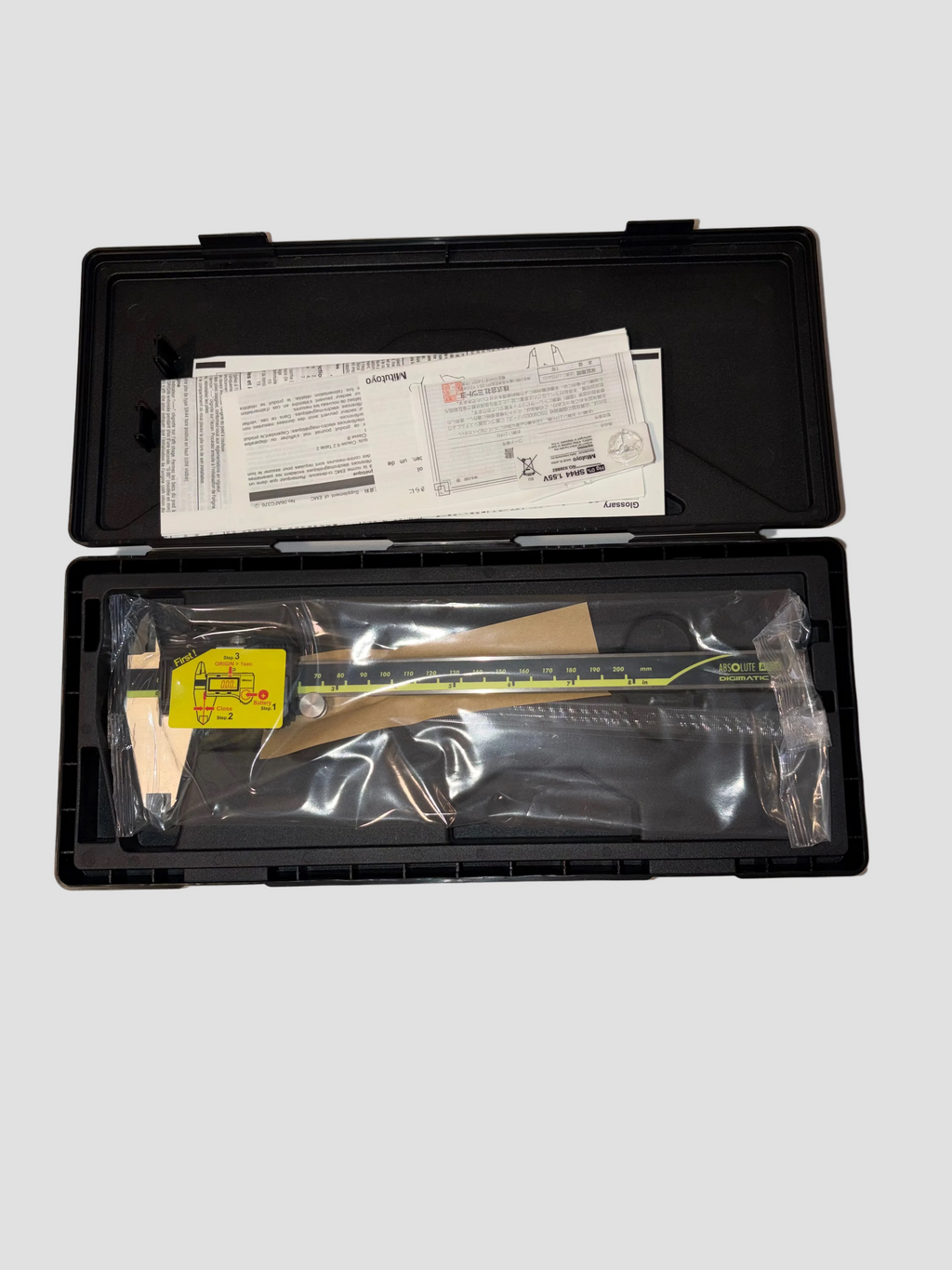 Caliper in a black case with a white label on a gray background