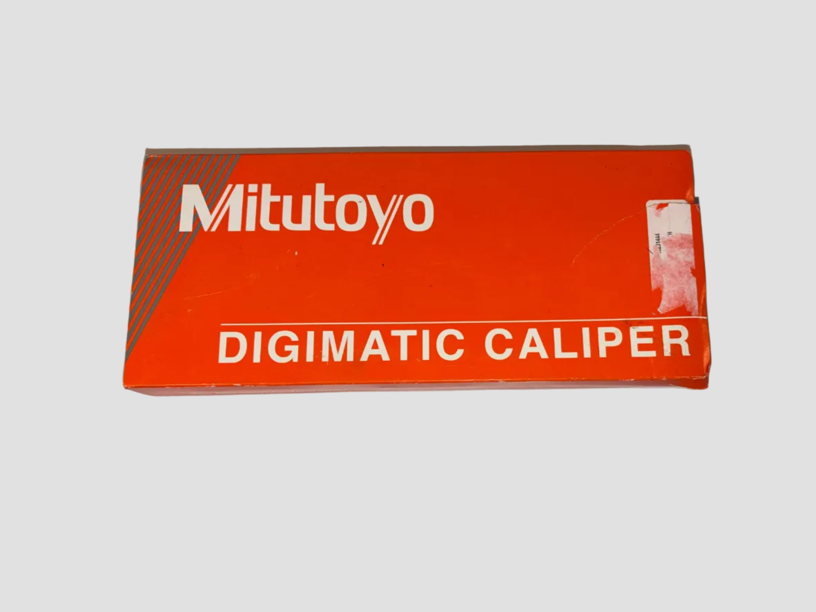 Mitutoyo Digimatic Caliper packaging on a gray background