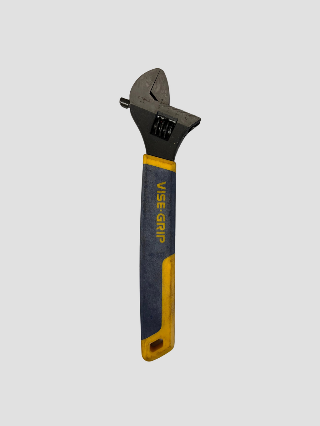 An adjustable wrench with a gray metal head and a handle featuring a blue and yellow ergonomic grip, branded with 'WISE GRIP'.
