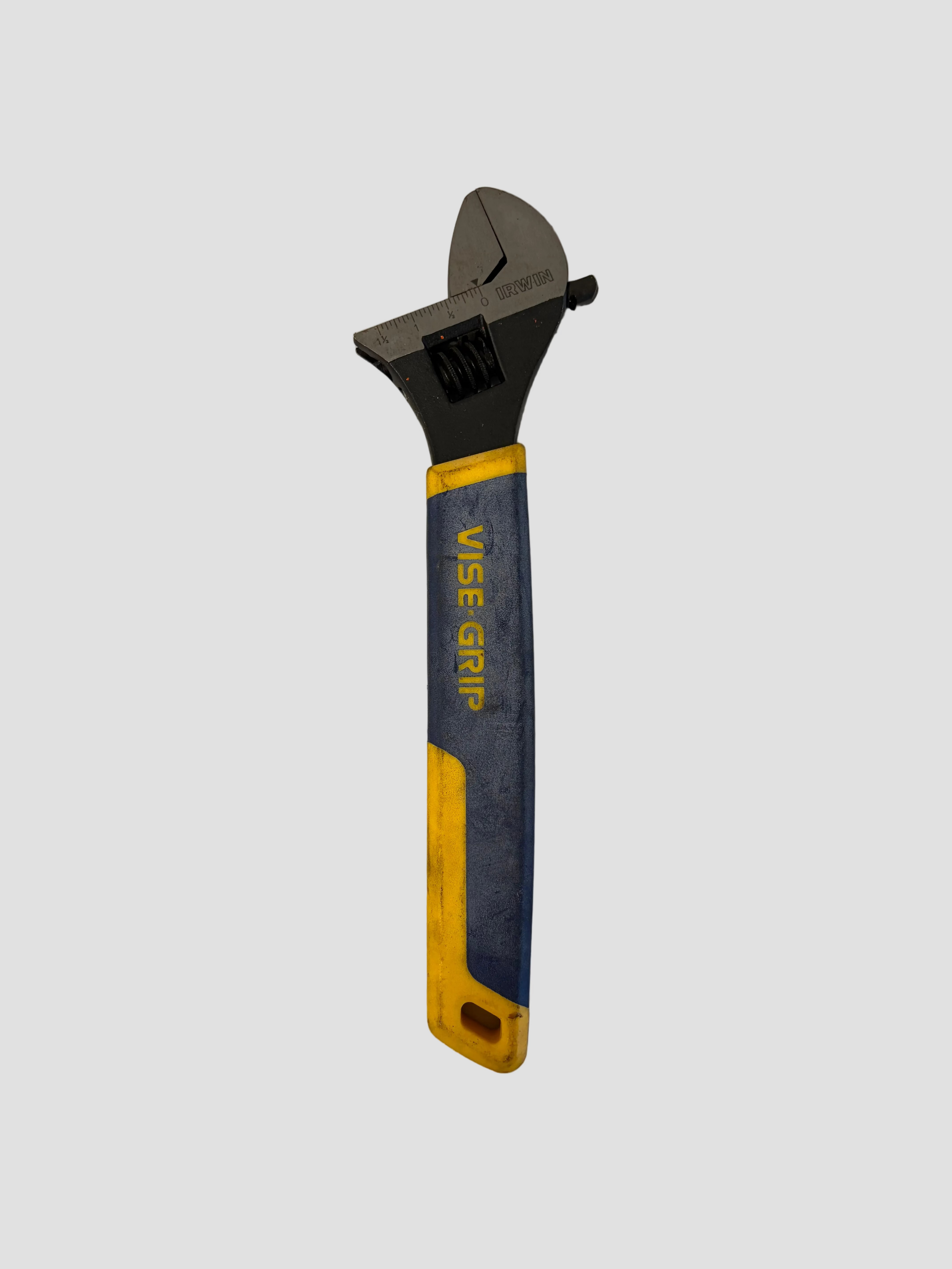 An adjustable wrench with a blue and yellow Vise-Grip handle, photographed on a plain light gray surface.