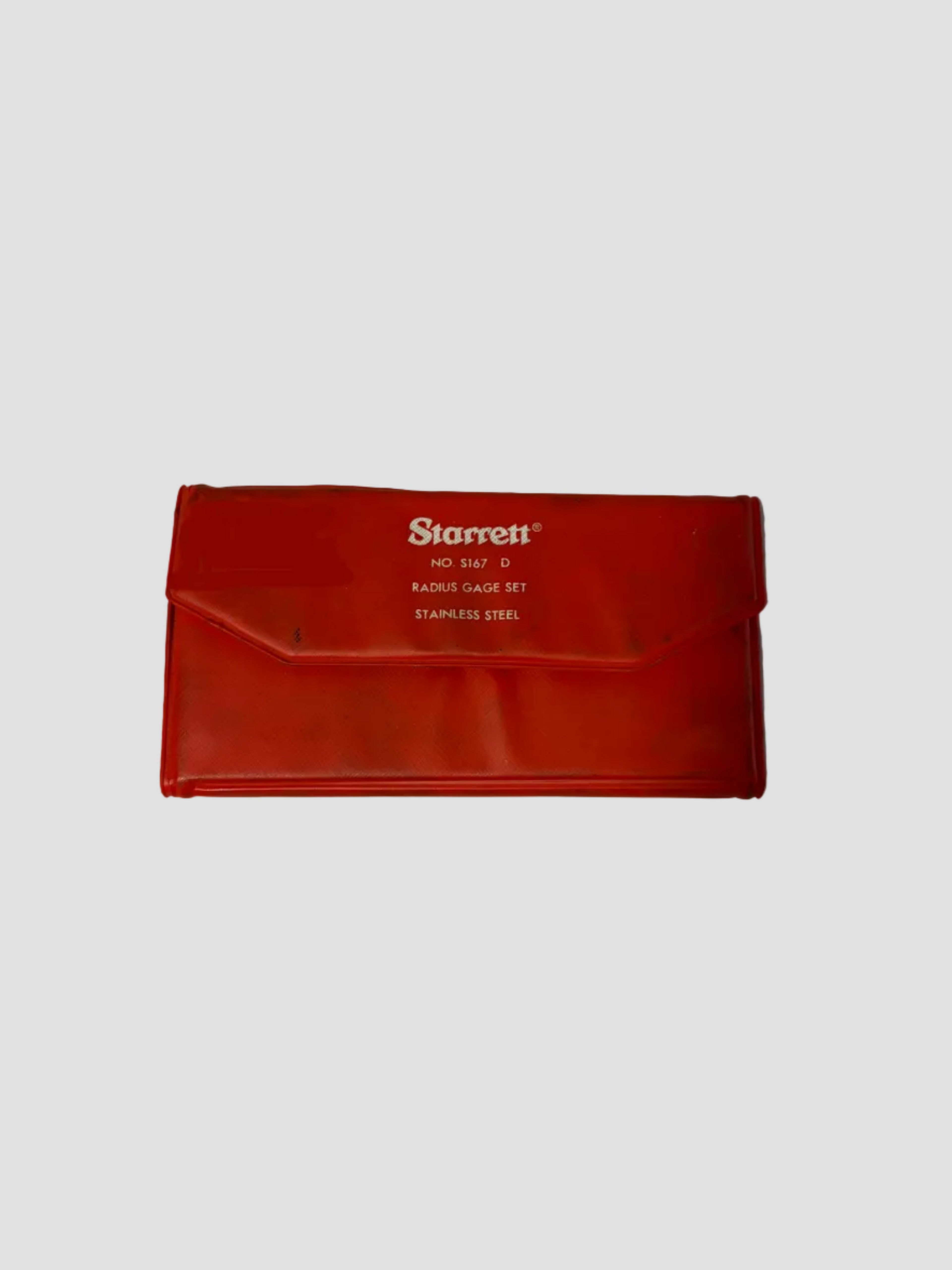 A red Starrett NO. 16 STAP D RADIUS CALIPER SET stainless steel gauge set, shown in its red plastic storage envelope on a light gray surface.