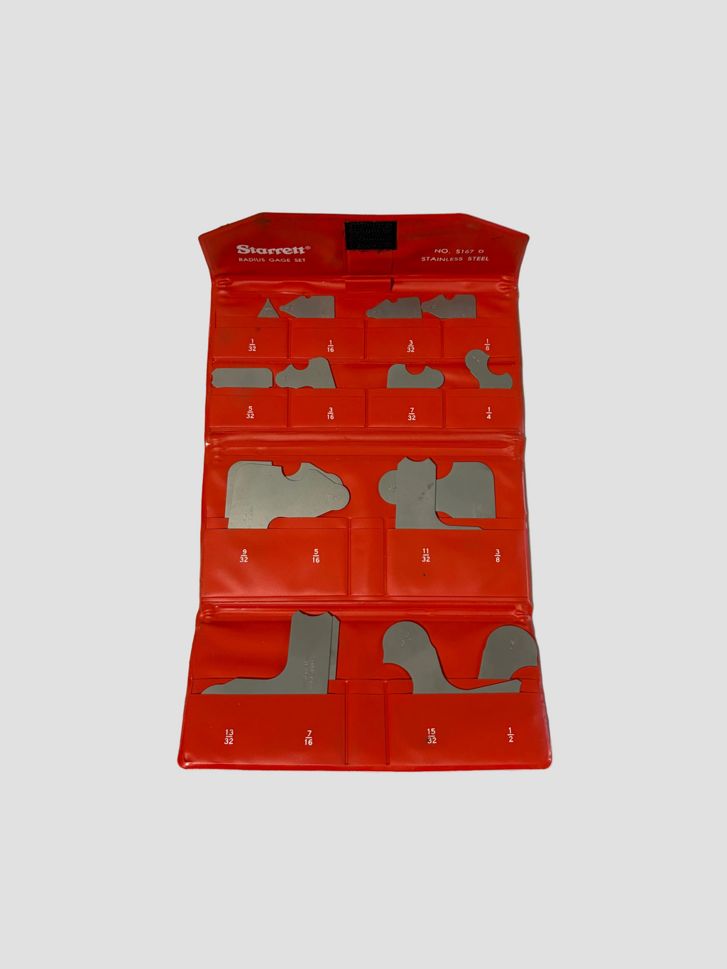 A red Sturett shoe template kit with multiple gray metal foot-shaped templates arranged inside a fold-out plastic case on a light gray surface.